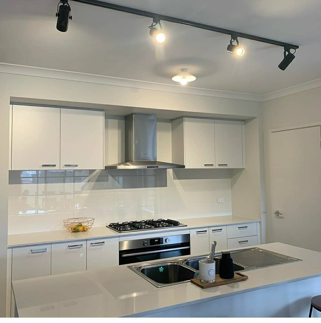 White kitchen with track lighting