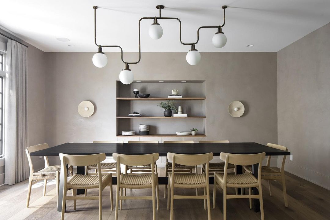 Kitchen with wooden table chairs and orb lights