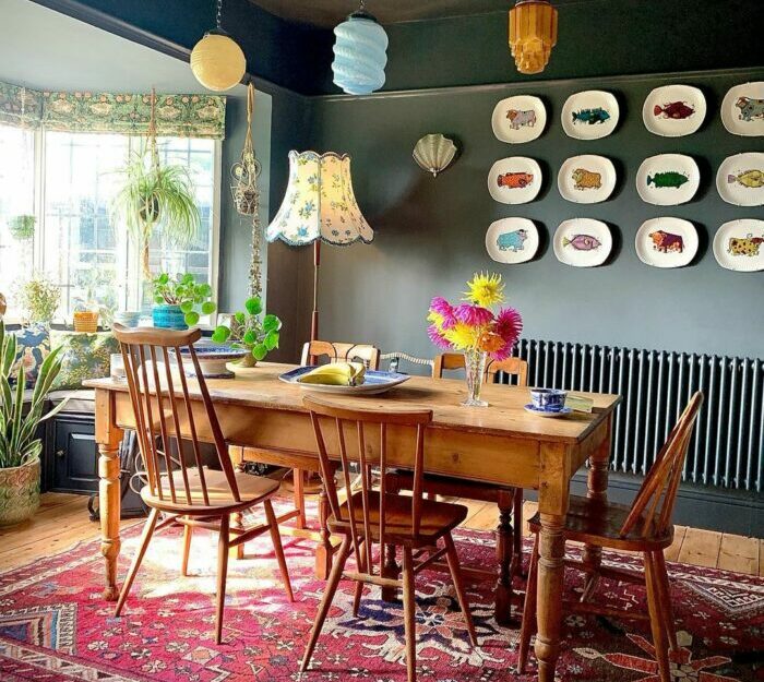 a maximalist room with a wooden dining set and animal-design wall decorations