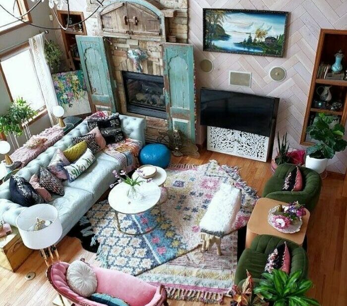 a top-down view of a maximalist living room with bold rugs, sofas, and vintage decor