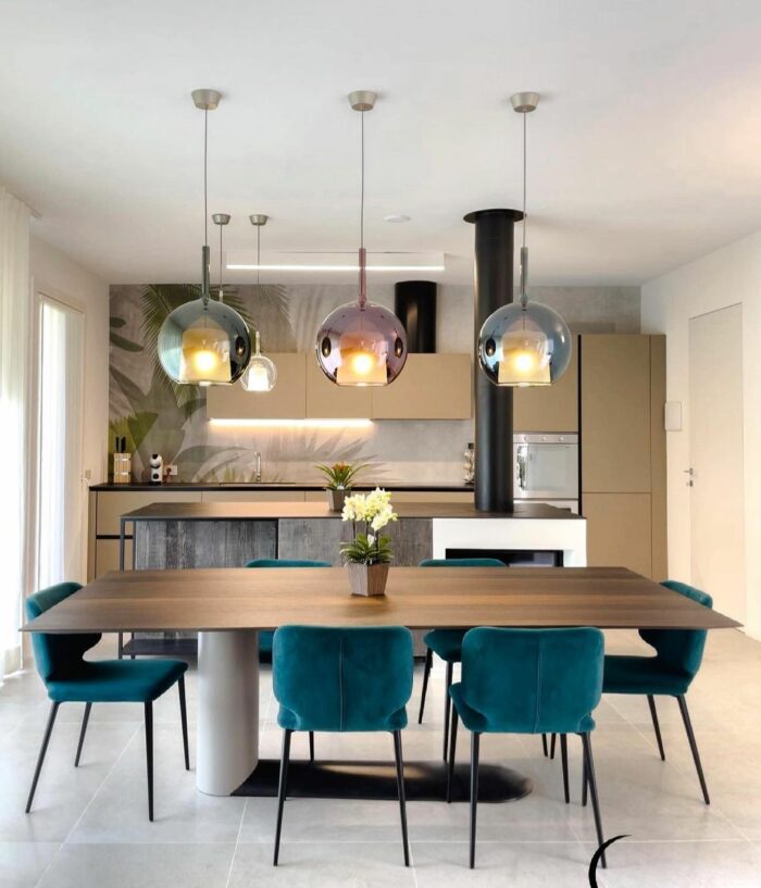 Kitchen with wooden table chairs and glass pendant with shades