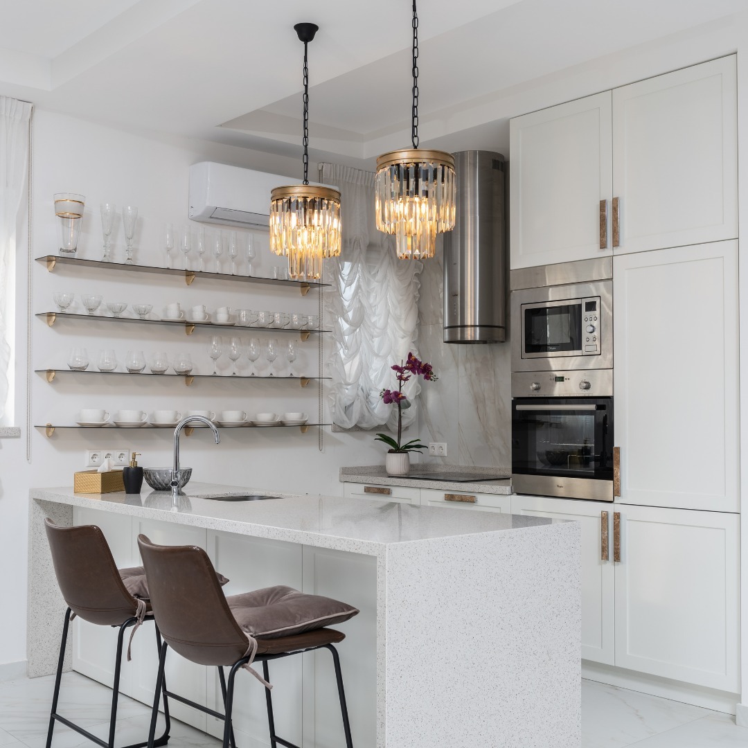 Kitchen with marble table open shelves and mini chandeliers