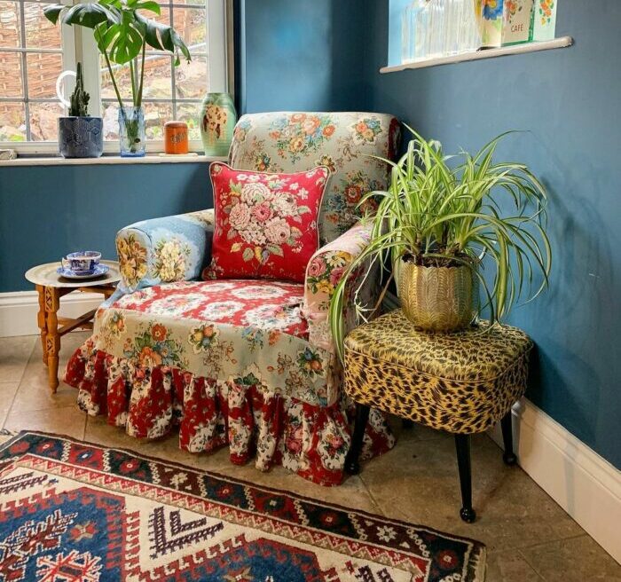a maximalist living room with a colorful chair made of many materials and patterns