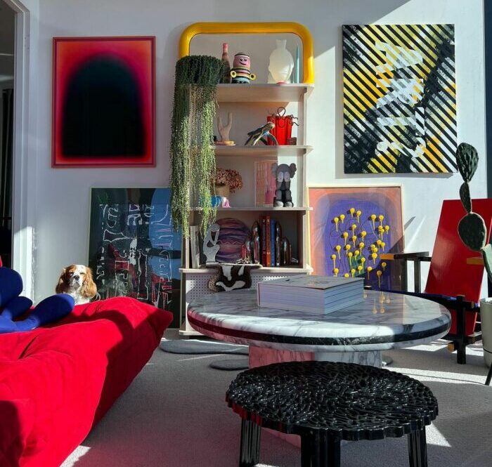 a maximalist living room with floor-to-ceiling windows, a colorful rug, and a marble coffee table a maximalist living room with floor-to-ceiling windows, a colorful rug, and a marble coffee table