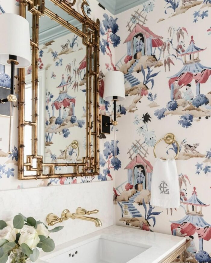 Bathroom with trendy chinoiserie wallpaper, gold fixtures, and a white sink showcasing stylish bathroom wallpaper ideas. Bathroom with trendy chinoiserie wallpaper, gold fixtures, and a white sink showcasing stylish bathroom wallpaper ideas.