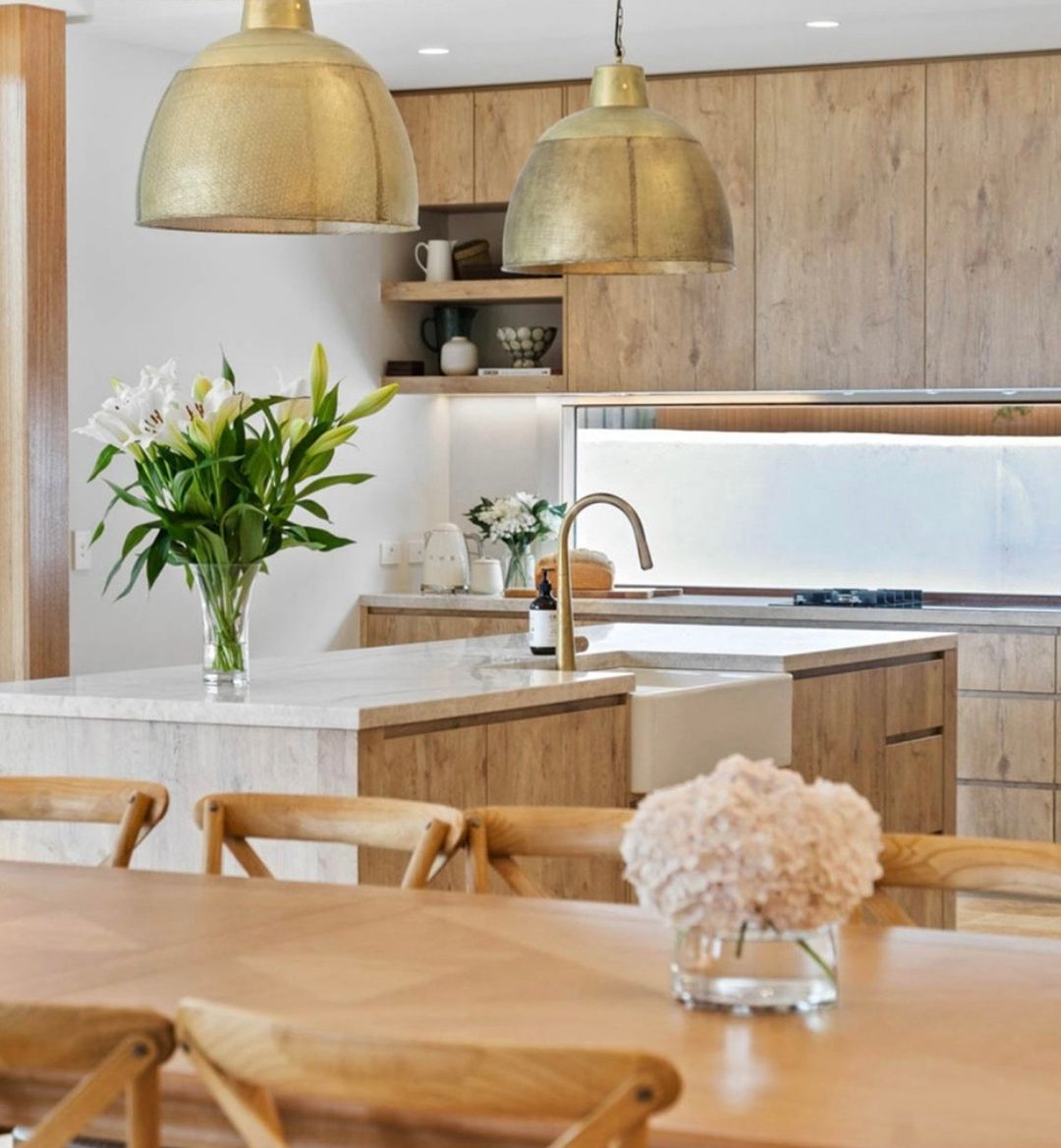 Luxury wooden kitchen with gilded lights and wooden furniture