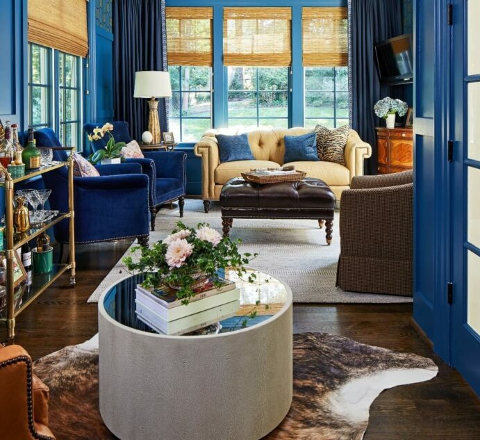 a maximalist living room with blue decor and sofas