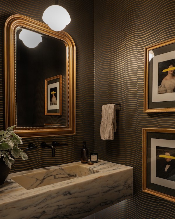 Bathroom with dark striped wallpaper and with marble sink