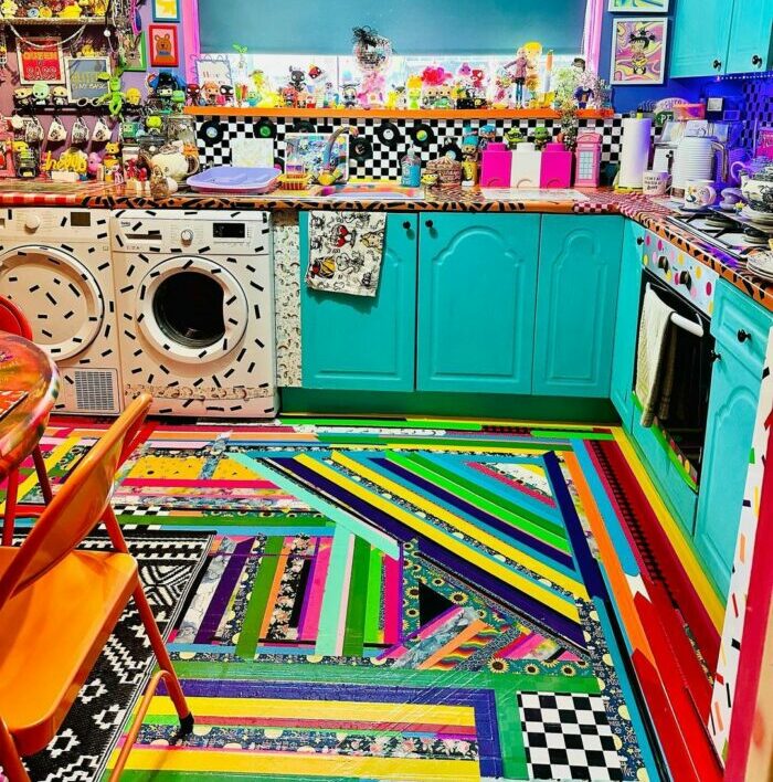 a colorful, maximalist kitchen with rugs, wall stickers, paintings, and many bright items a colorful, maximalist kitchen with rugs, wall stickers, paintings, and many bright items