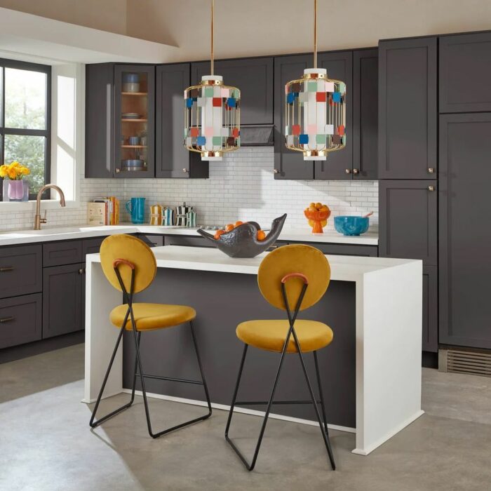 Black kitchen with white table chairs and colorful lights