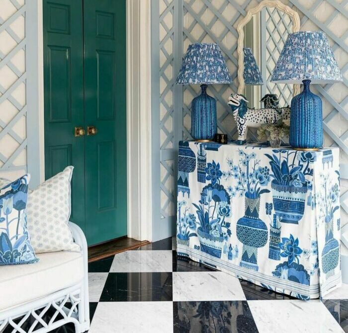 a maximalist entryway with a green doorway and blue decor