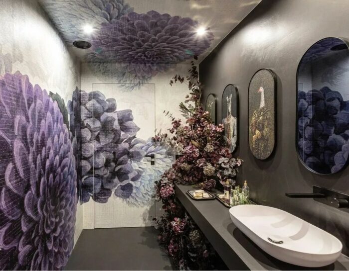Bathroom with textured purple flower wallpaper and cupboard with sink