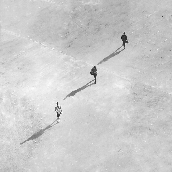A photograph of three people walking 