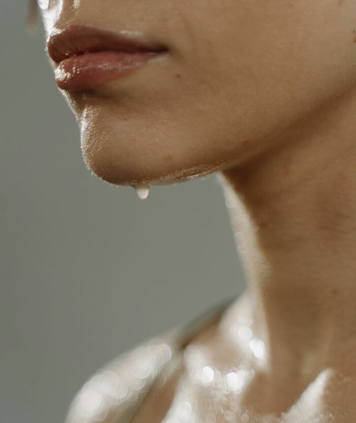 Close up photo of a woman face sweating