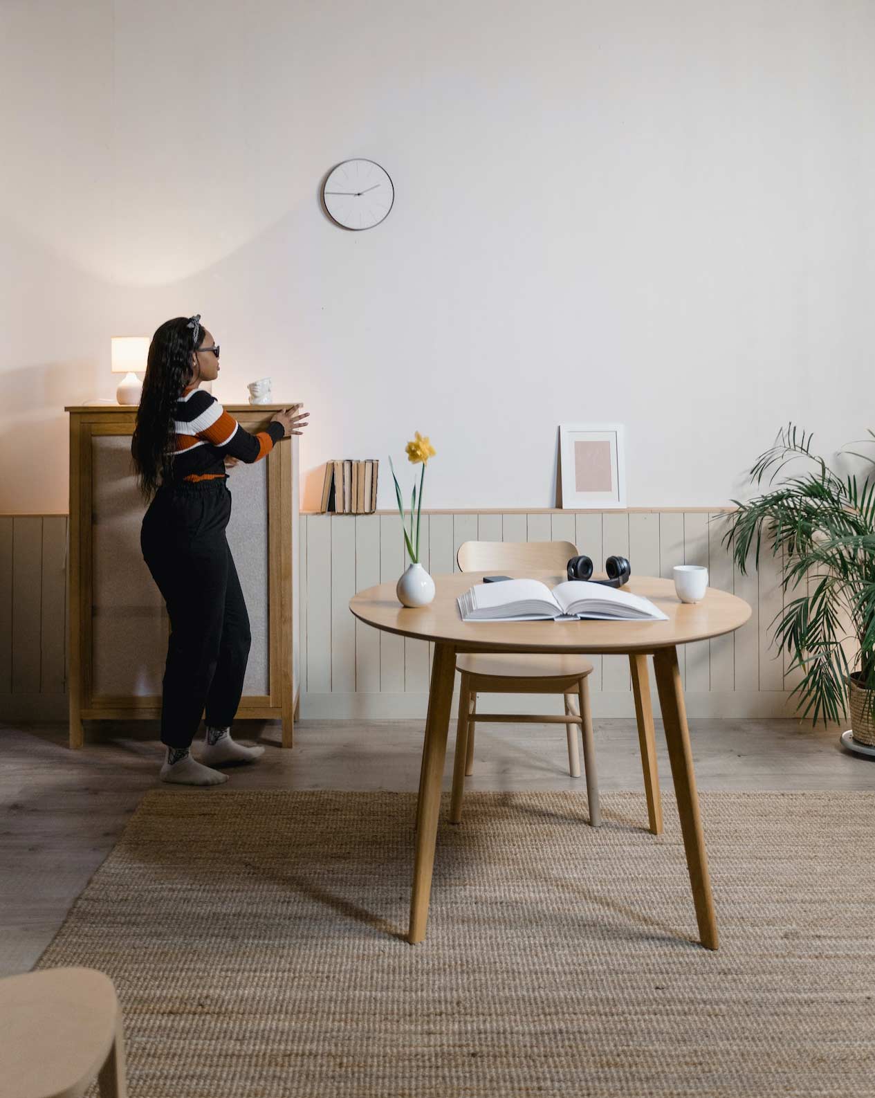 A woman walking in a tidy room A woman walking in a tidy room