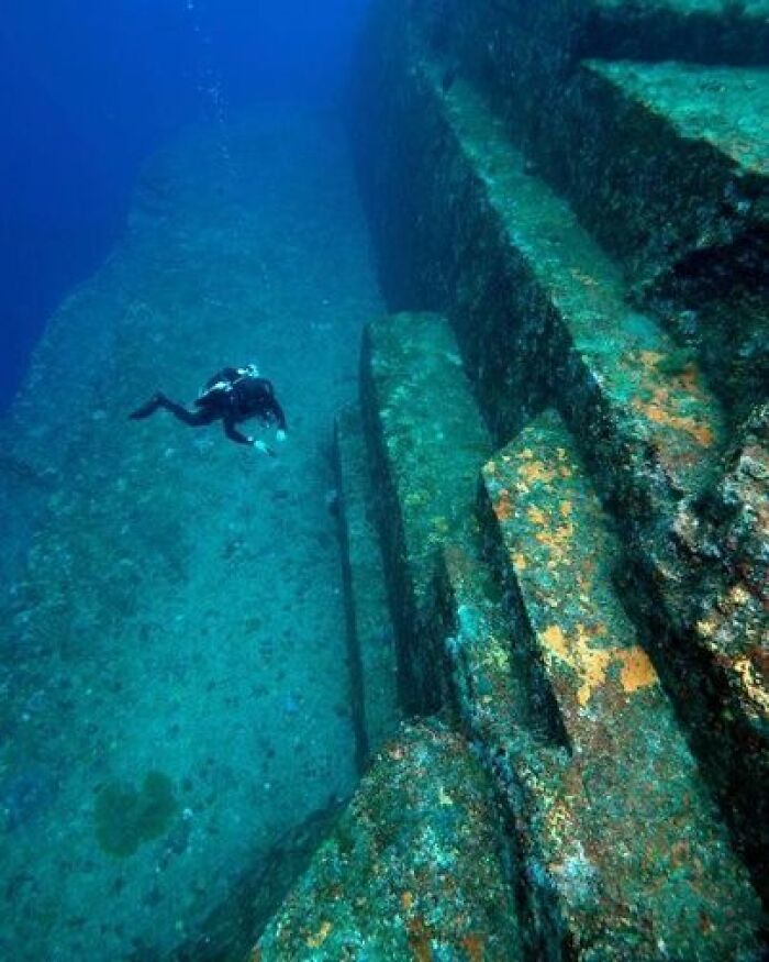 Captured Underwater, A Diver Delves Into The Depths Of The Submerged "Yonaguni" Site Located Off The Coast Of Japan. The Question Arises: Is This Site A Product Of Human Artifice Or A Result Of The Relentless Forces Of Erosion And The Wonders Of Mother Nature? What Are Your Thoughts On This Intriguing Mystery?