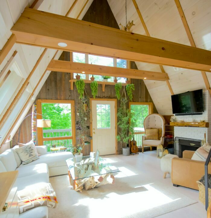a minimalist room with white furniture, wooden aesthetics, and a triangular roof a minimalist room with white furniture, wooden aesthetics, and a triangular roof