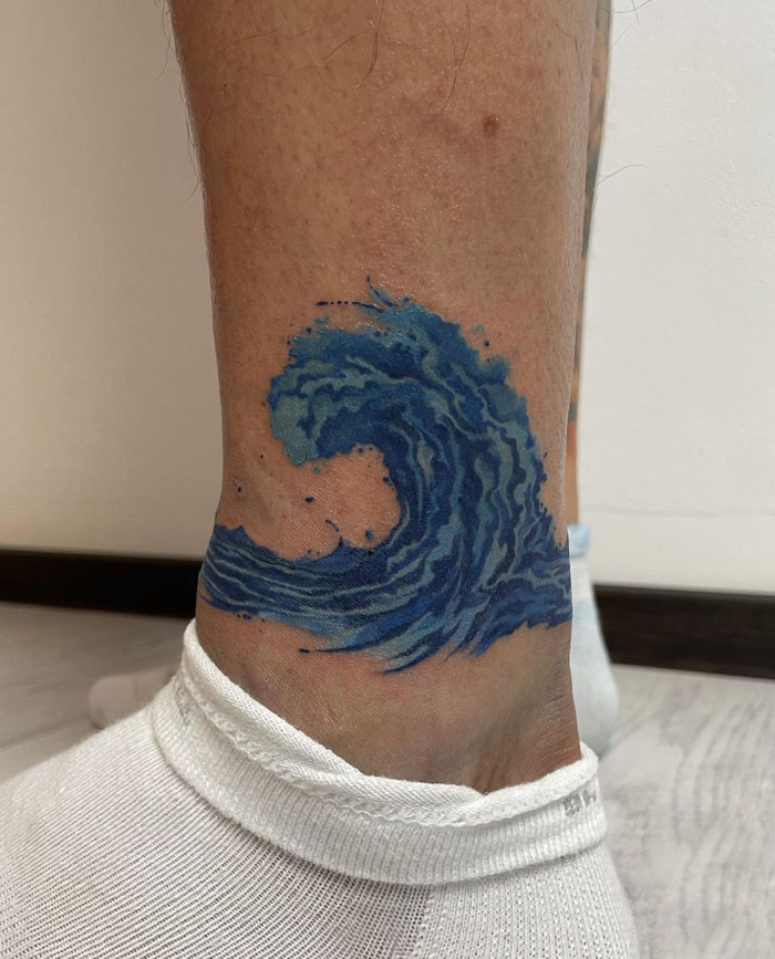 Watercolor ocean wave ankle tattoo
