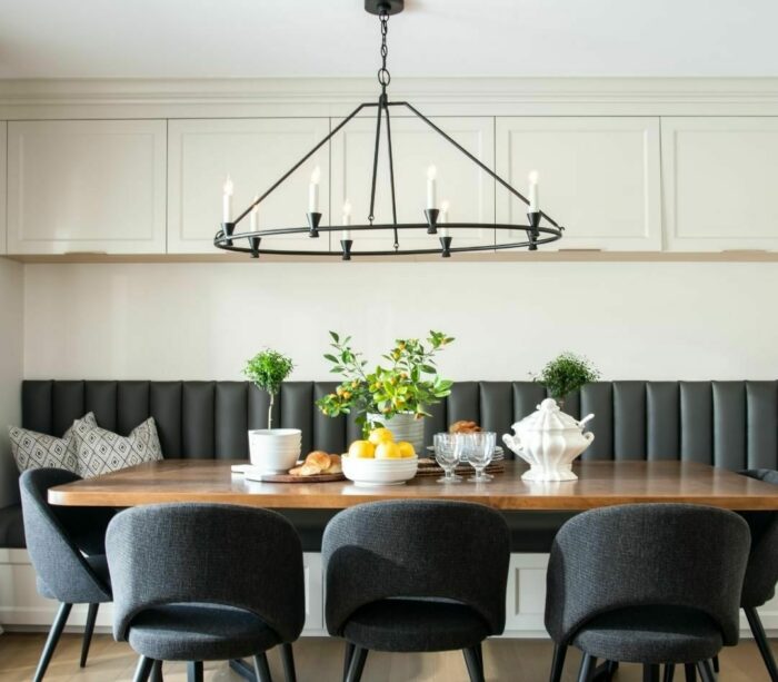 Black banquette with wooden table and black chairs