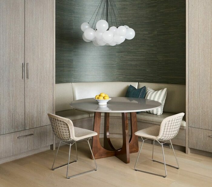 Gray banquette with green patterned wall