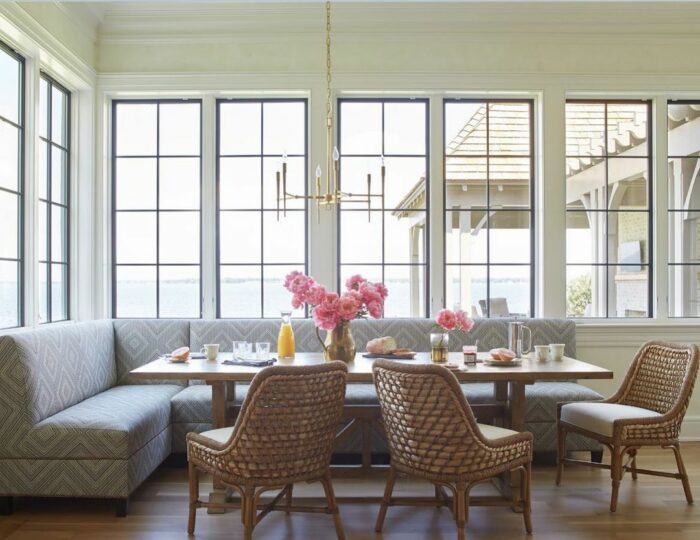 Patterned gray banquette with wooden table and chairs
