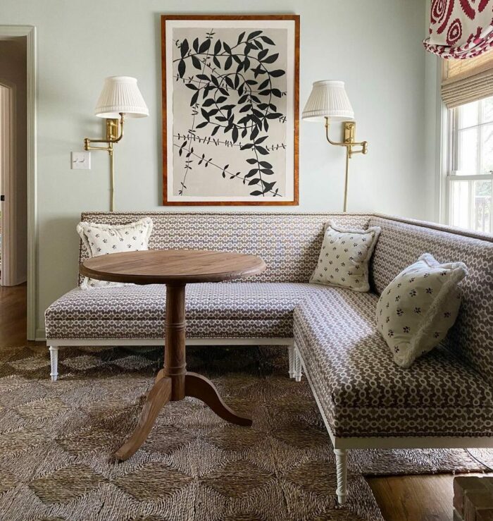 Patterned banquette with pillows and wooden table