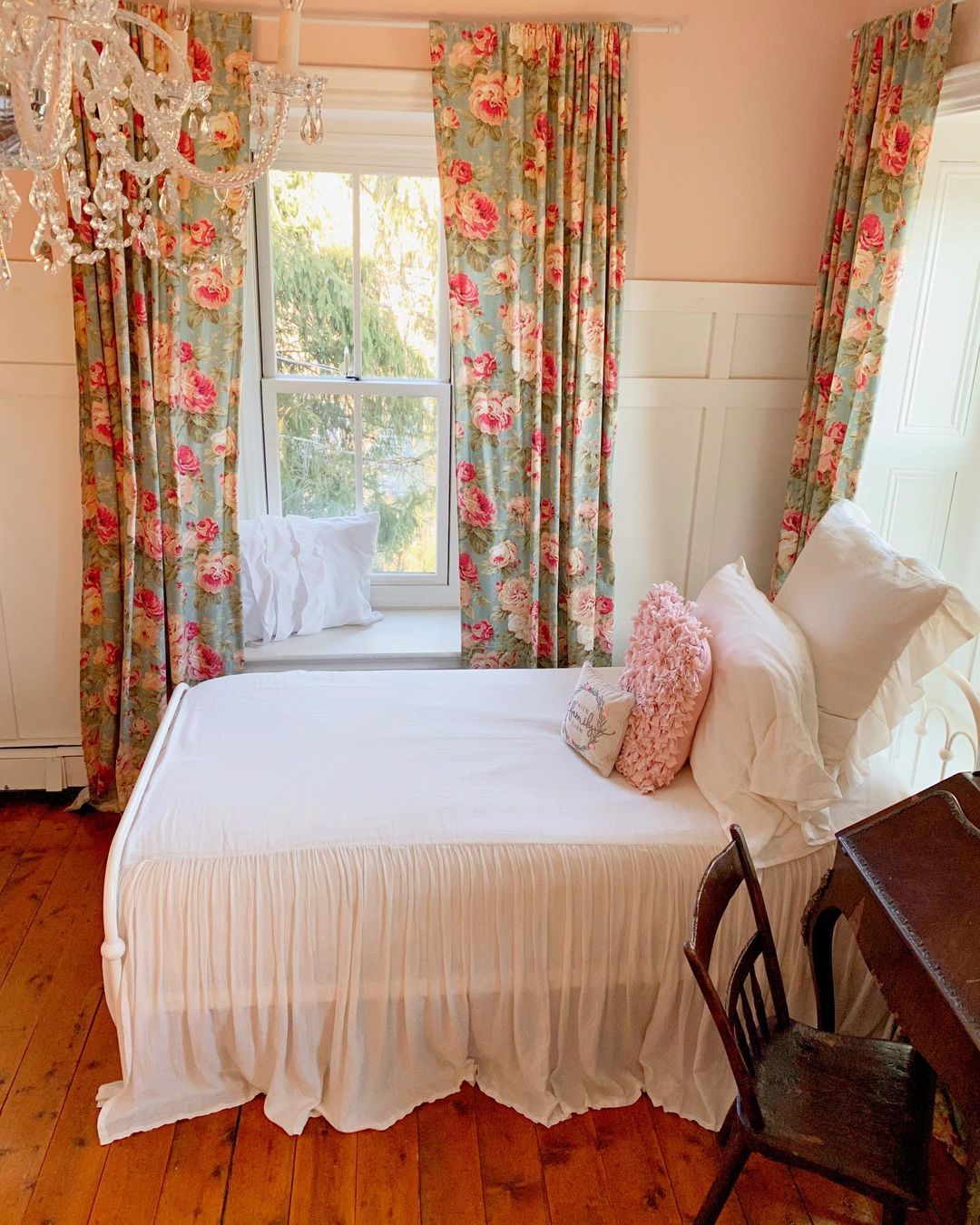 bed on the background of window with floral curtains