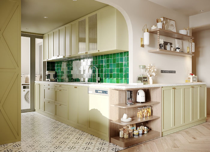 A kitchen with green kitchen cabinets and dark green tile in the wall