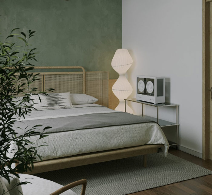 A bedroom with bed and nightstand lamp near it 