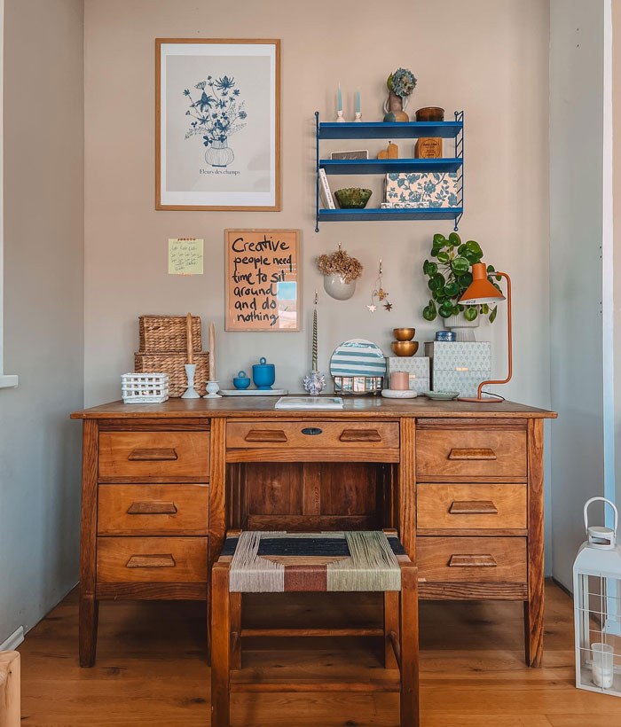 Vintage desk and chair styled with boho decor accents including plants, candles, and framed artwork for a chic space. Vintage desk and chair styled with boho decor accents including plants, candles, and framed artwork for a chic space.