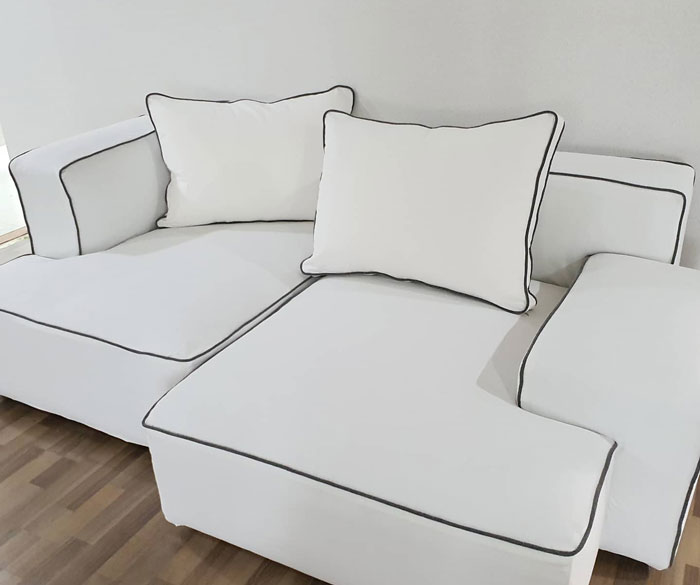 White couch slipcover with black edges