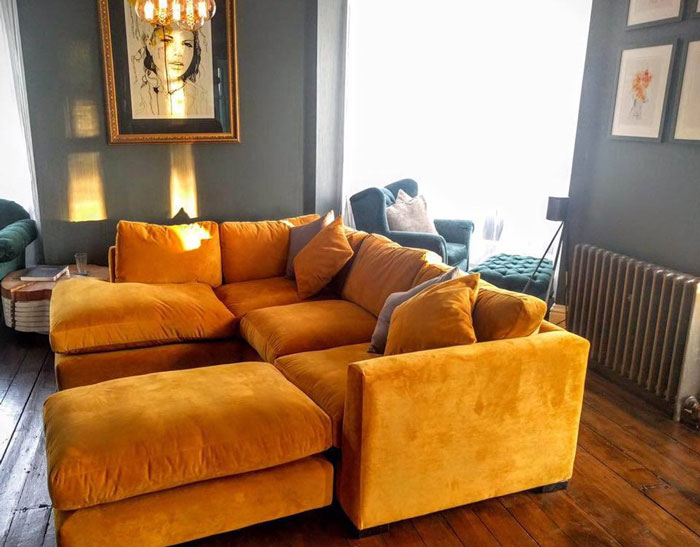 Big mustard coloured convertible couch 