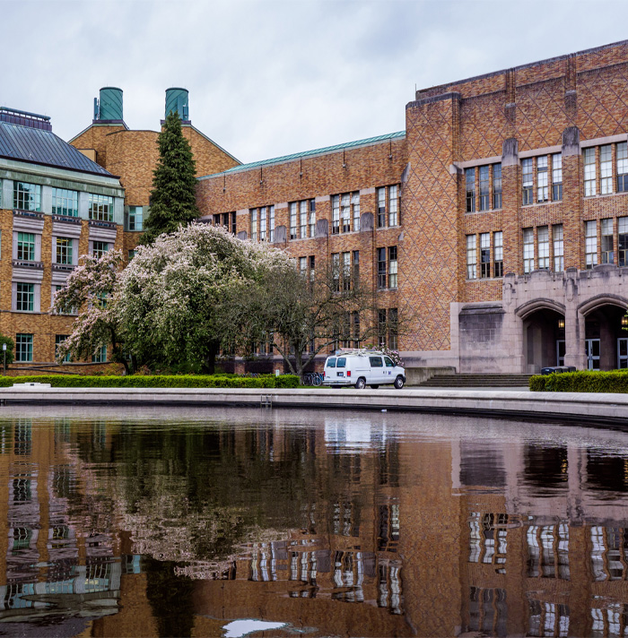 Old brick building with overcast sky and reflective pool in front, evoking a setting for scary facts and heebie-jeebies.