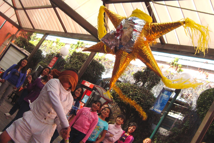 Kids breaking piñata at Las Posadas in Mexico