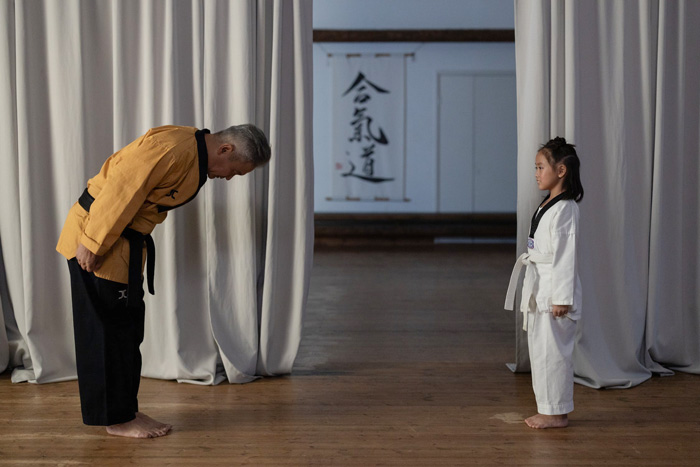 A martial arts instructor bowing to a student