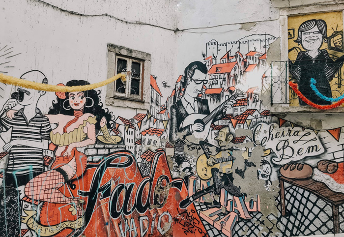 Graffiti on white wall containing the word 'fado' on it in Lisbon, Portugal