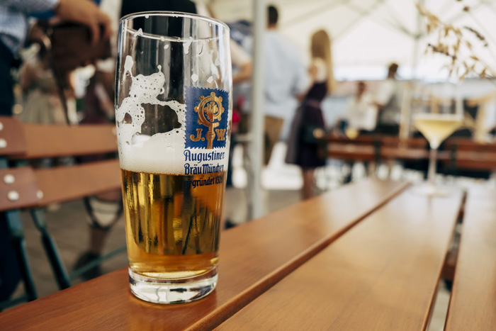 A glass of beer placed on a wooden table