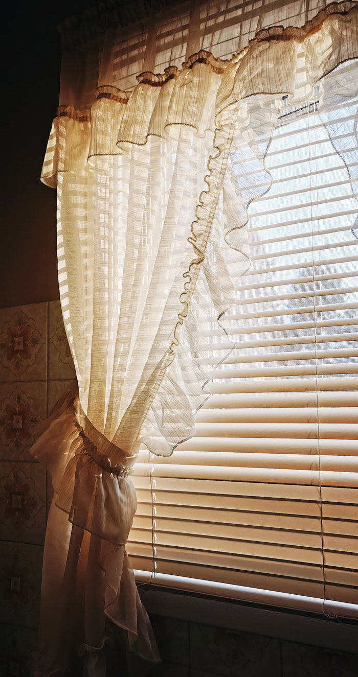 ruffled curtain decorating a window