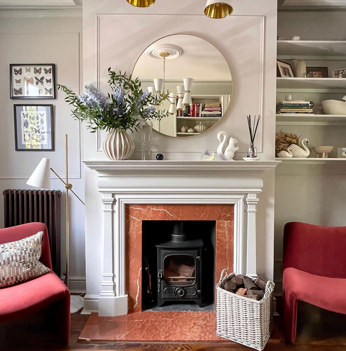 Bright living room with red marble fireplace and white detailed mantle