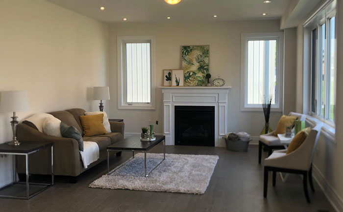 Simple white fireplace mantel with stacked artwork above, creating a clean and elegant hearth design in a modern living room. Simple white fireplace mantel with stacked artwork above, creating a clean and elegant hearth design in a modern living room.
