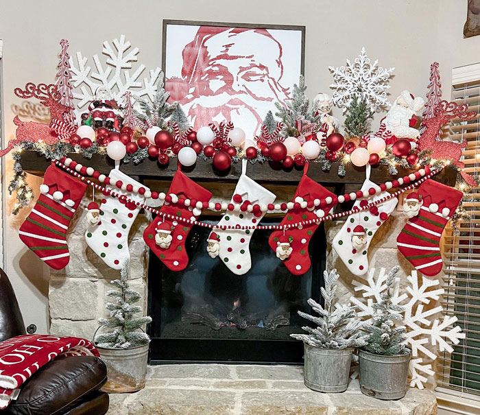 Christmas themed living room fireplace with christmas stockings