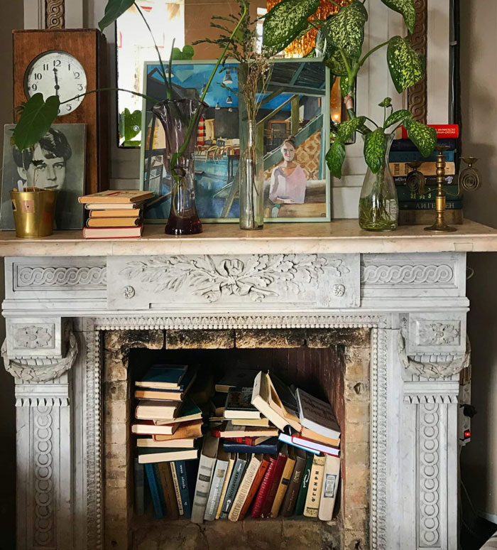 antique fireplace with books inside it 
