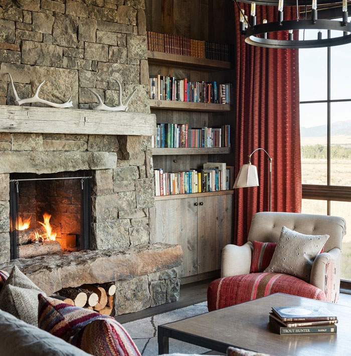 Raised living room fireplace with stone mantel and built-in firewood storage for cozy hearth ideas. Raised living room fireplace with stone mantel and built-in firewood storage for cozy hearth ideas.