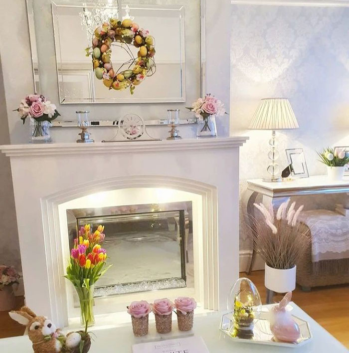 white fireplace with bright colored spring decorations on the mantle