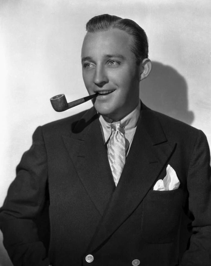 Bing Crosby with the smoking pipe wearing suit 