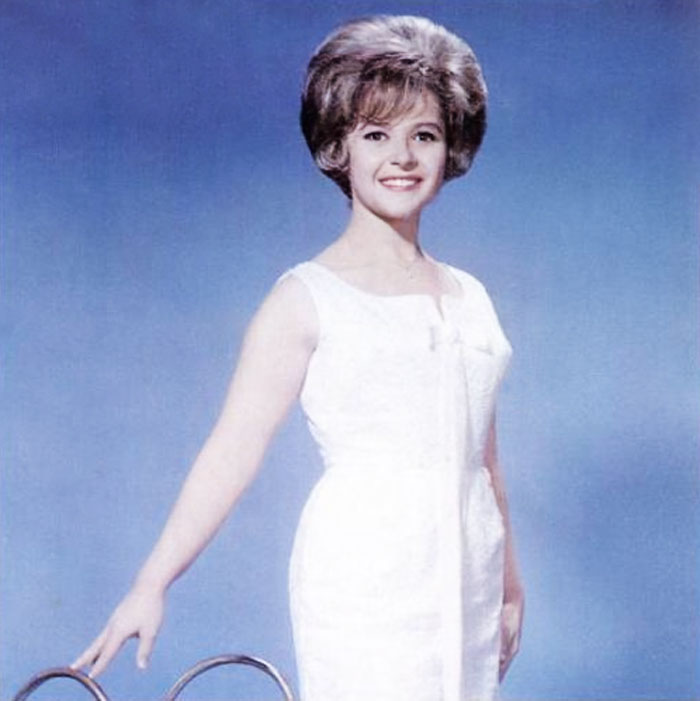Brenda Lee wearing white dress 