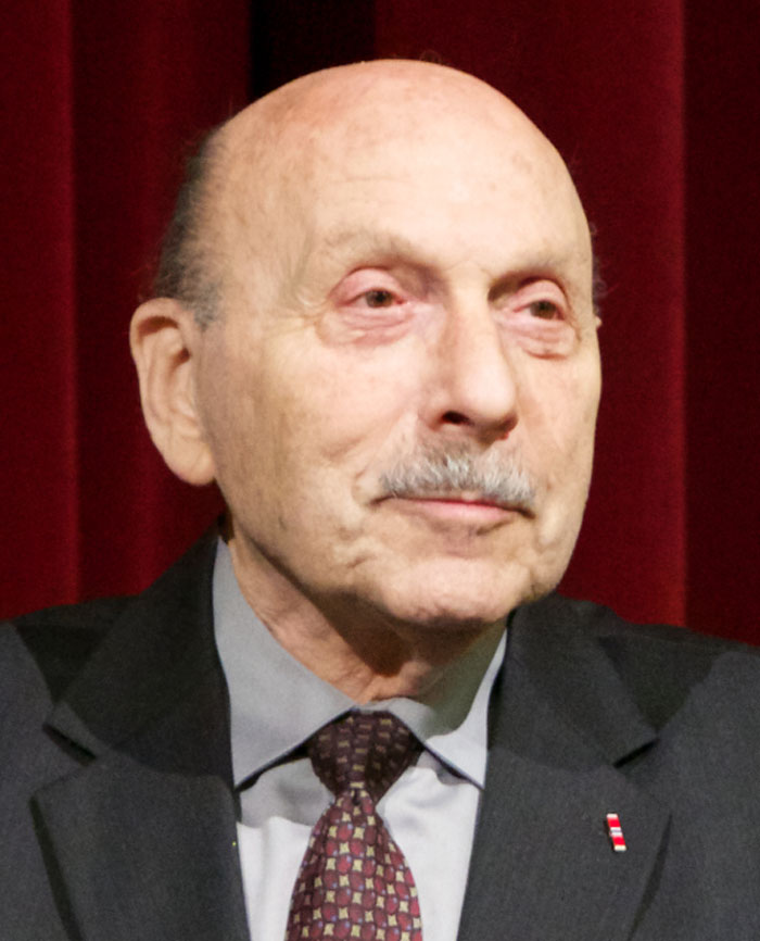 Stanley Weintraub wearing suit with mustache 