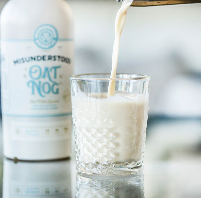 Person pouring eggnog in the glass 