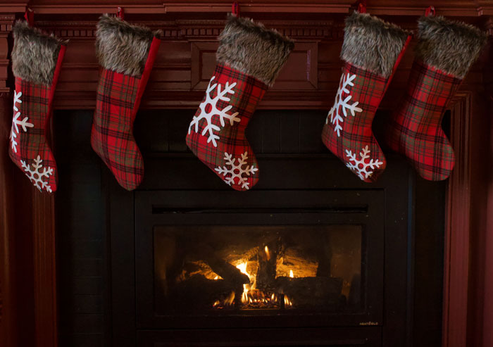 Red Christmas stocking hanging on fireplace 