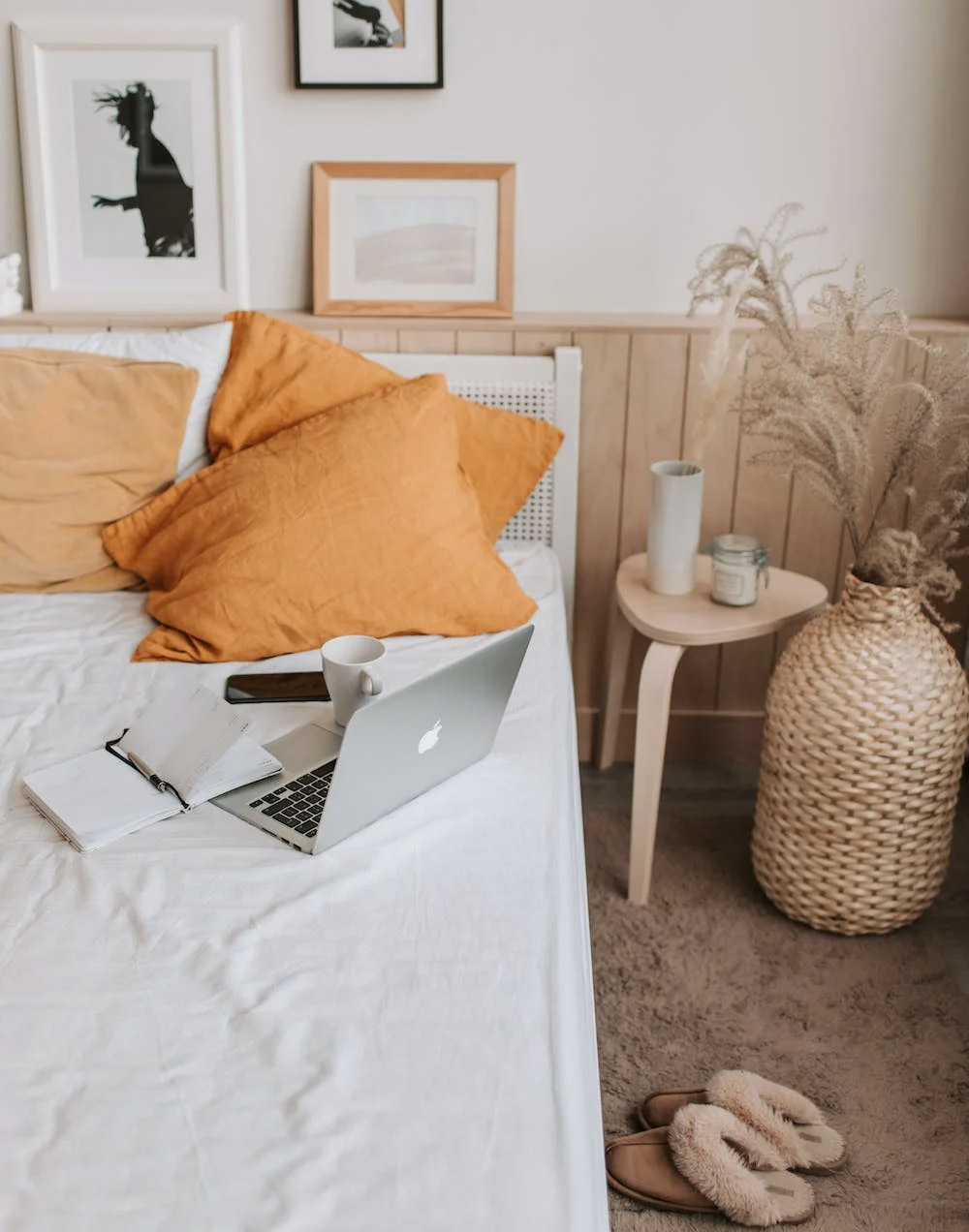 Bed with laptop and pillows